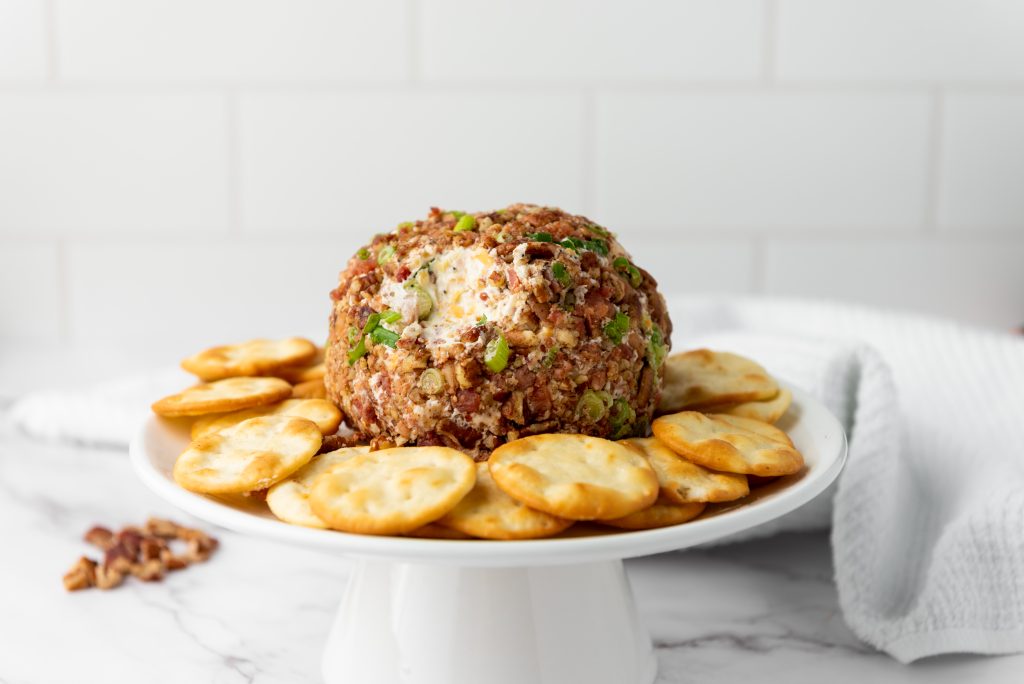 cheeseball on a plate with crackers