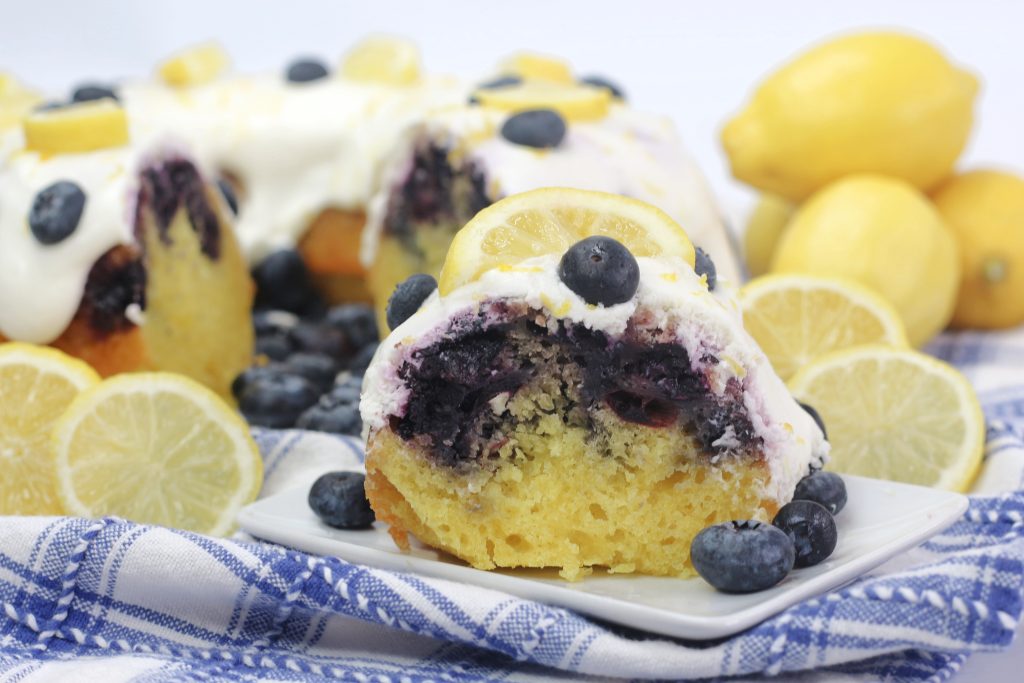 closeup of a slice of cake on a plate with blueberries