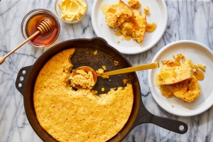 <img src="your-image-url.jpg" alt="Golden corn spoonbread baked to perfection in a rustic ceramic dish, garnished with fresh chives and ready to serve">

